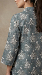 Close-up back view of the 3/4 sleeve and all-over white cherry blossom print on a premium steel blue luxury lawn shirt