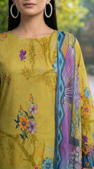 Back view of a model turning on an autumn tree-lined avenue in a chartreuse olive luxury lawn suit with tonal vine and multicolour wildflower print, bold teal ikat cuff border, plain olive yellow palazzo trousers, and teal-to-lavender chiffon dupatta with oversized purple magnolia blooms trailing behind