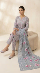 Close-up portrait of a model in a dove grey cherry blossom lawn suit with a powder blue peony chiffon dupatta draped across the chest, antique gold chandelier earrings, looking down