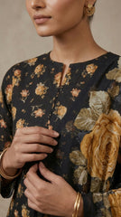 Close-up of the round neckline with button placket and flared bell sleeve detail on a charcoal black golden rose printed luxury lawn shirt, matching chiffon dupatta draped across
