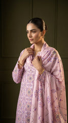 Full length front view of a model seated in a lilac geometric print luxury lawn suit with cascading printed chiffon dupatta