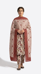 Back view of a model in an antique ivory Pakistani luxury lawn suit with dense burgundy and olive botanical floral print and a contrast geometric ikat stripe bamber chiffon dupatta with crimson border, beige studio background
