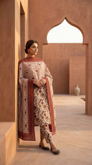 Side profile of a model walking in an antique ivory botanical floral lawn suit with a cascading contrast ikat stripe chiffon dupatta with rich crimson border, Mughal courtyard background