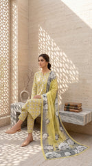 Back view of a model in a citrine yellow Pakistani luxury lawn suit with oversized grey peony print and a cascading contrast grey-yellow bamber chiffon dupatta, standing under stone arches