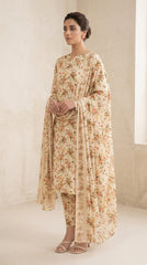 Back view of a model walking in a cream botanical print 3-piece lawn suit with a flowing matching bamber chiffon dupatta, bright studio background
